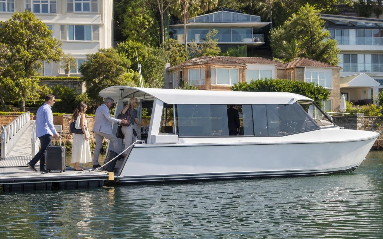Guests boarding a water taxi at a private harbourside pontoon